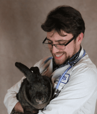 Jason Doll holding his Flemish giant rabbit named Buckbeak