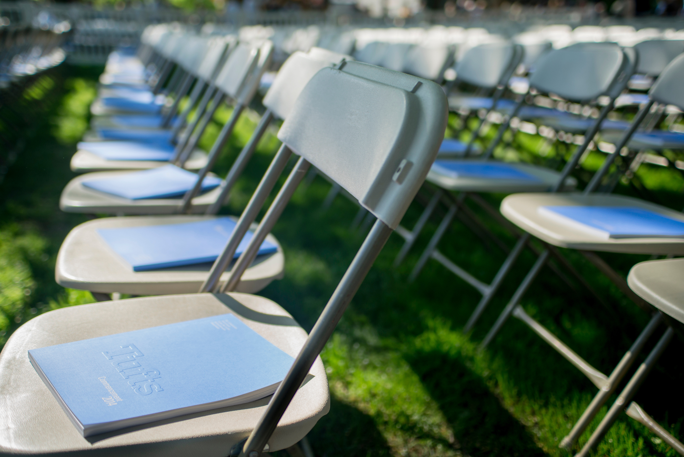 Chairs topped with Commencement booklets lined up on the Academic Quad.