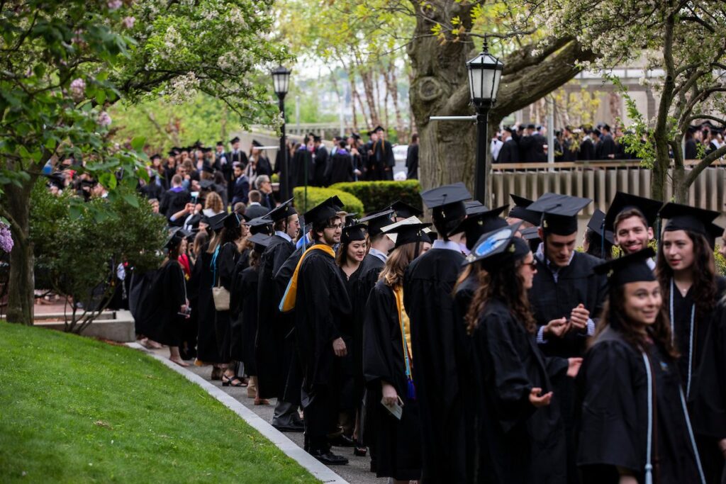 Students line up outside for Commencement. 