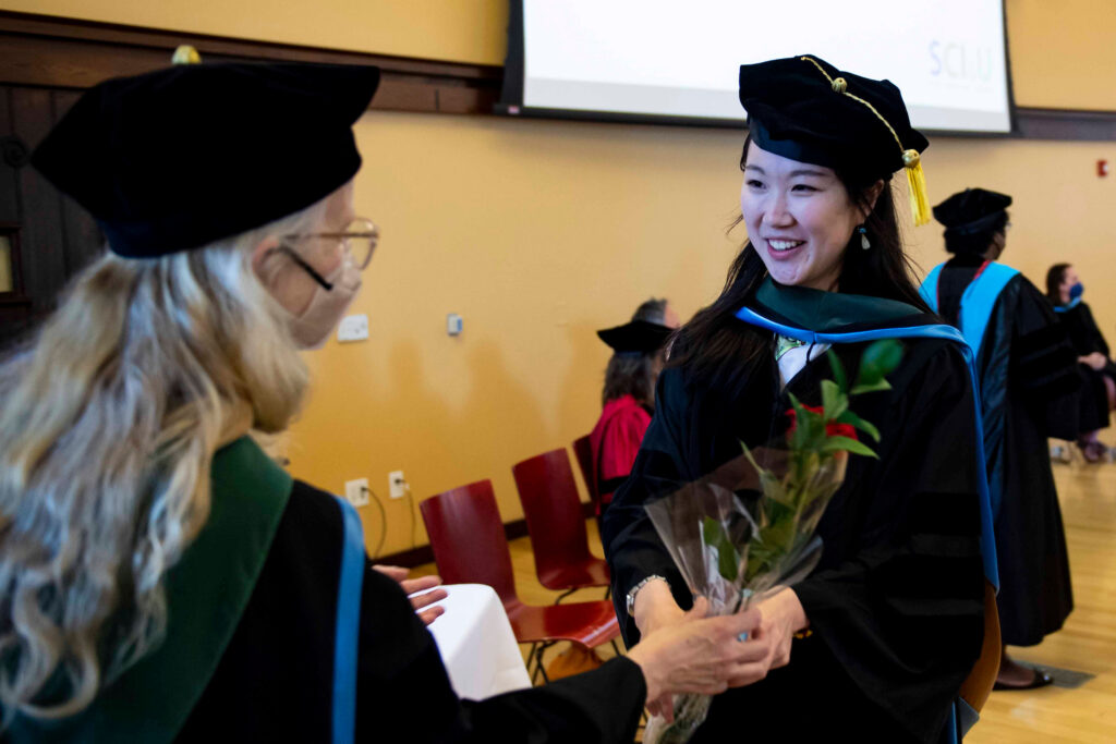 Commencement attendees greet each other.