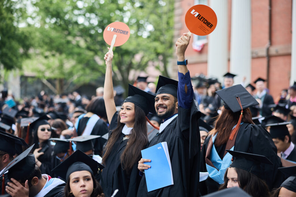 Fletcher students wave fans in the air at Commencement.
